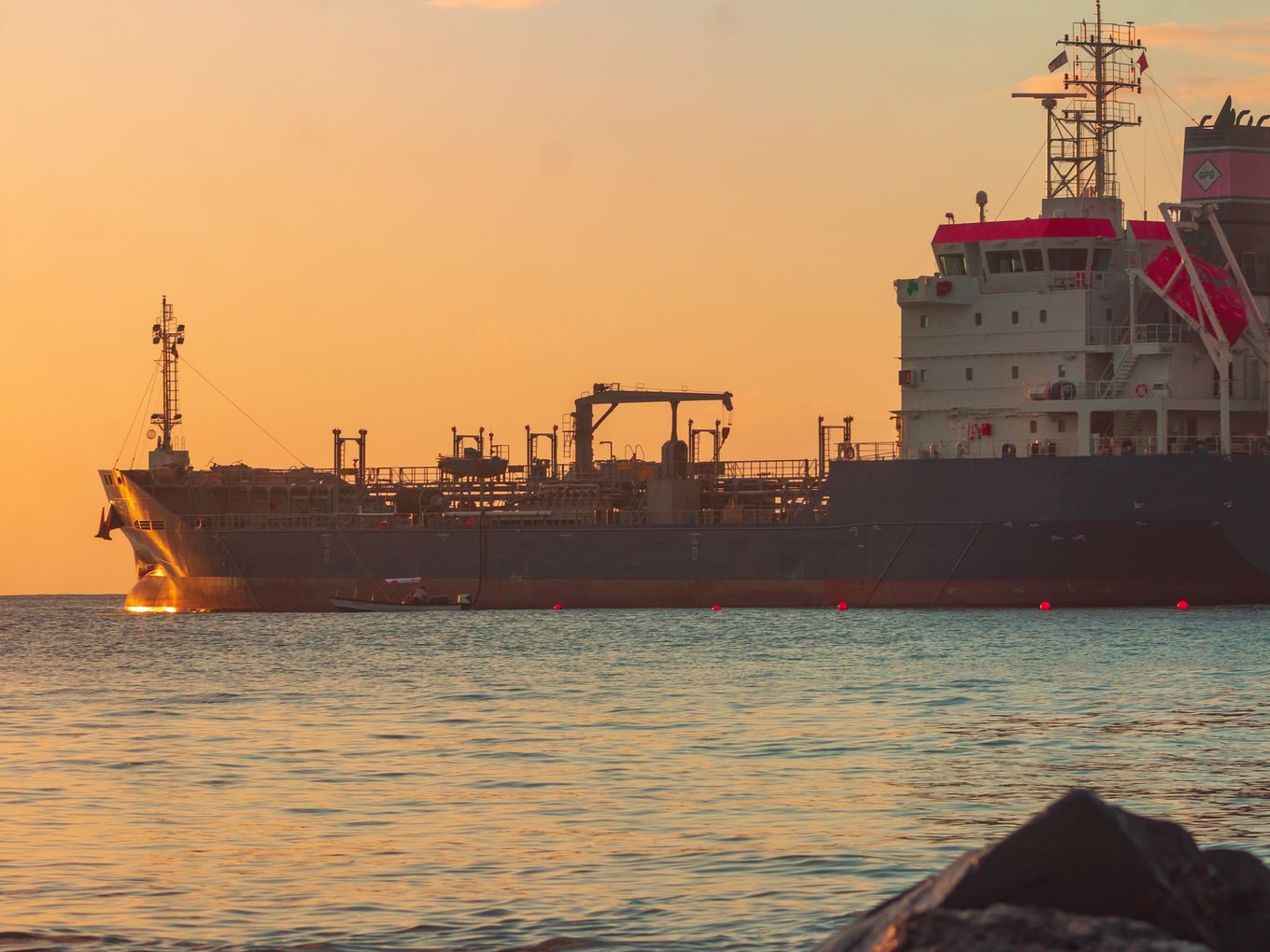 Oil tanker off the coast at dusk